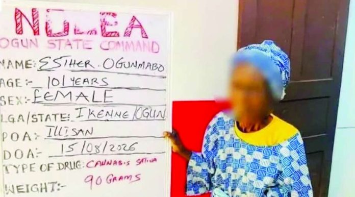 Nigeria_copy_compressed_resized The 101-year-old Nigerian Esther Ogunmabo is photographed alongside her offence board after she was arrested for selling cannabis. Ogunmabo said she started selling illicit drugs after her shop was destroyed in a fire. NDLEA