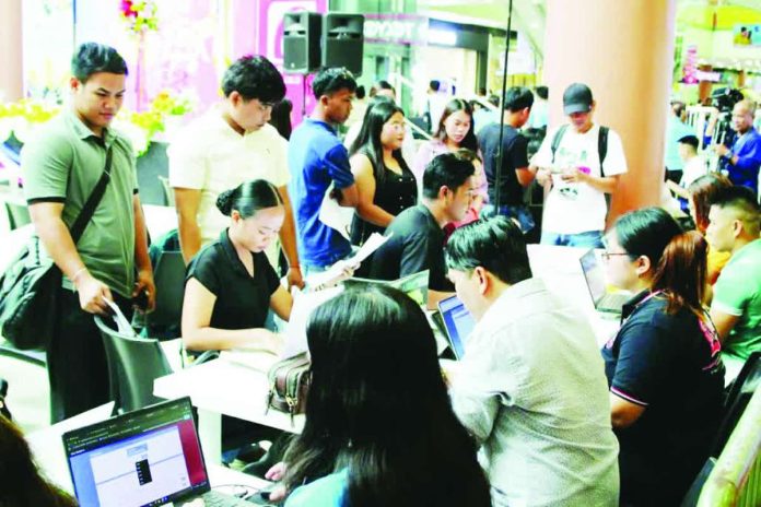 PH_employment_compressed_resized Applicants line up for screening and on-the-spot interviews during a local recruitment activity in Iloilo City. The job fair brought together employers and job seekers as part of efforts to expand employment opportunities amid improving labor market conditions.