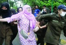 Pakistan gov’t restricts int’l media reporting A protester is detained as others gather in support of the banned Joint Awami Action Committee (JAAC), an alliance of Kashmir's civil society groups, during a demonstration in Lahore, Pakistan. EPA