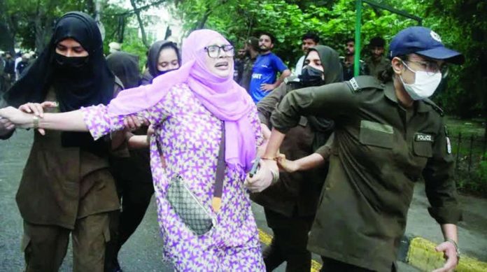 Pakistan_compressed_resized A protester is detained as others gather in support of the banned Joint Awami Action Committee (JAAC), an alliance of Kashmir's civil society groups, during a demonstration in Lahore, Pakistan. EPA