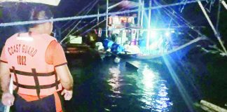 A Coast Guard responder monitors the recovery of the fishing banca Taga Bukid after rescuers found the vessel off Culasi, Antique and safely evacuated its eight fishermen during a nighttime rescue operation. PHOTO COURTESY OF SN1 ADONIS, PHILIPPINE COAST GUARD