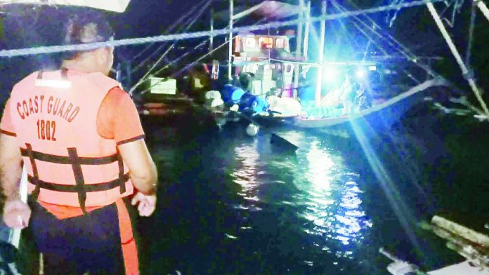 A Coast Guard responder monitors the recovery of the fishing banca Taga Bukid after rescuers found the vessel off Culasi, Antique and safely evacuated its eight fishermen during a nighttime rescue operation. PHOTO COURTESY OF SN1 ADONIS, PHILIPPINE COAST GUARD
