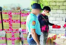 Patnongon police officers inspect boxes containing 900 reams of "Cannon" brand cigarettes valued at around P900,000 following an anti-smuggling operation in Barangay Apgahan, Patnongon, Antique, on August 29, 2026. PHOTO COURTESY OF PRO-6