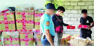 Patnongon police officers inspect boxes containing 900 reams of "Cannon" brand cigarettes valued at around P900,000 following an anti-smuggling operation in Barangay Apgahan, Patnongon, Antique, on August 29, 2026. PHOTO COURTESY OF PRO-6