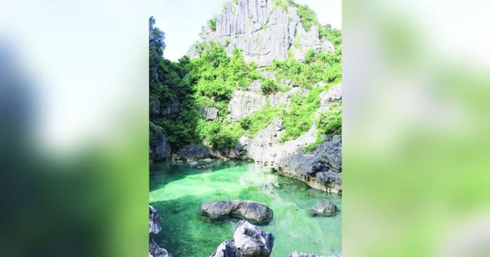 Known for its naturally enclosed saltwater pool surrounded by towering limestone formations, the Tangke “Saltwater” Lagoon is among the flagship ecotourism attractions of the Gigantes Group of Islands in Carles, Iloilo. PHOTO BY CARLES TOURISM OFFICIAL FACEBOOK PAGE