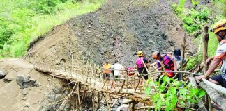 Personnel from the Office of the Provincial Disaster Risk Reduction and Management Office–Antique conduct an on-site assessment of a rain-induced landslide in Barangay Alojipan, Culasi town. The southwest monsoon or habagat triggered a landslide last July that damaged the makeshift bridge serving as the community's primary access rout. The Mines and Geosciences Bureau Region 6 previously identified several barangays in Culasi as highly susceptible to rain-induced landslides. OPDRRMO-ANTIQUE PHOTO