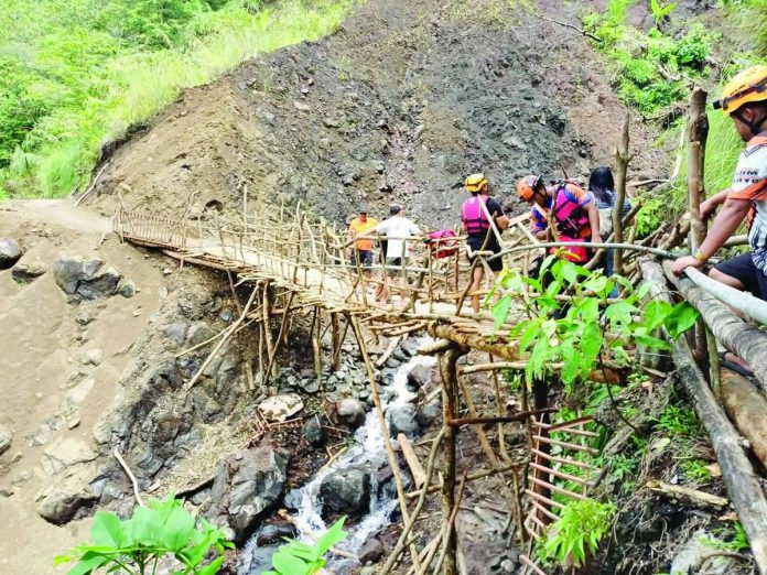 landslide_(1)_compressed_resized Personnel from the Office of the Provincial Disaster Risk Reduction and Management Office–Antique conduct an on-site assessment of a rain-induced landslide in Barangay Alojipan, Culasi town. The southwest monsoon or habagat triggered a landslide last July that damaged the makeshift bridge serving as the community's primary access rout. The Mines and Geosciences Bureau Region 6 previously identified several barangays in Culasi as highly susceptible to rain-induced landslides. OPDRRMO-ANTIQUE PHOTO