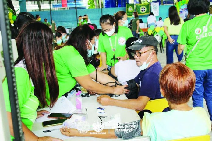 neljoy_TB_copy_compressed_resized Department of Health medical personnel check residents’ blood pressure during a community outreach activity in Iloilo City aimed at promoting early disease detection and encouraging residents to seek timely medical care. DOH-6