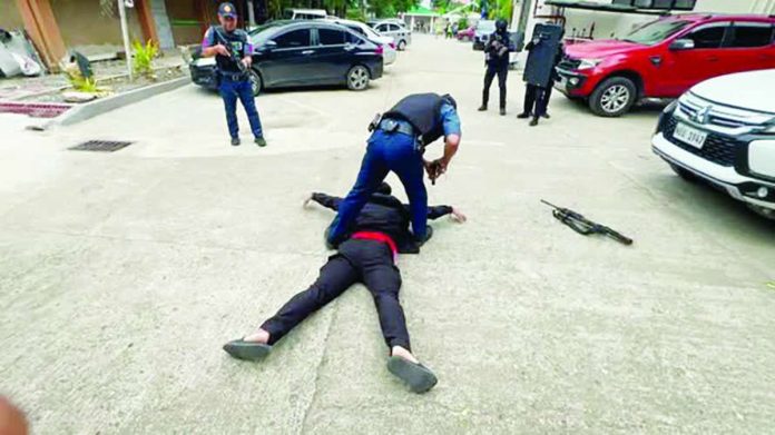 neljoy_active_shooter1_compressed_resized PINNED TO THE GROUND. A policeman immobilizes and disarms an “active shooter” at the Department of Education - Region 6 compound in Iloilo City during a full-scale Active Shooter Incident Awareness, Response, and Simulation Exercise. The drill tested coordinated law enforcement, medical, and evacuation procedures to strengthen preparedness for potential active shooter incidents in schools and government workplaces. DEPARTMENT OF EDUCATION – REGION 6