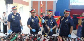 GUNS OFF THE STREETS. Police Regional Office 6 officials inspect some of the 858 undocumented and unregistered firearms voluntarily surrendered across Western Visayas from May 15 to July 31 under Project R.T.T., or Restrict, Track and Turn-in. The weapons were presented at Camp Martin Teofilo Delgado in Iloilo City on August 10. AJ PALCULLO/PN