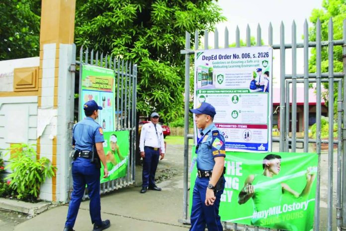 Police officers maintain a visible presence at the entrance of La Paz I Elementary School in Iloilo City as authorities continue security measures in schools despite the postponement of the active-shooter simulation exercise. Police Regional Office 6 says sustained police visibility is intended to deter potential threats and assure students, teachers and parents of a safer learning environment. ALLEN ANIMAS/PN