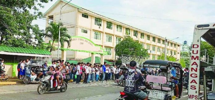 neljoy_socmed_copy_compressed_resized Students of Dumangas National High School in Dumangas, Iloilo gather outside their campus after the suspension of their classes due to the threatening social media posts of a teacher. PHOTO BY DUMANGAS ANG BANWA KO