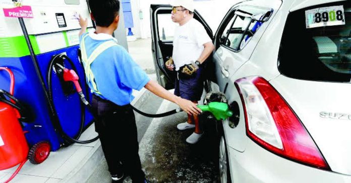 oil_price_next_week_compressed_resized A gasoline station attendant caters to a customer in this undated photo. Fuel prices are projected to rise by as much as P2.25 per liter next week given the same path in the international market. PNA FILE PHOTO