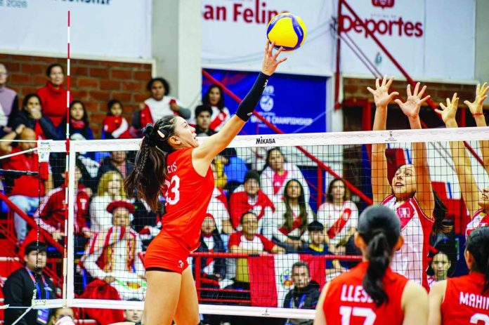 Caera Celis of the Philippines hammers the ball against the defense during the FIVB Volleyball Girls’ U17 World Championship in San Felipe, Chile. FIVB PHOTO
