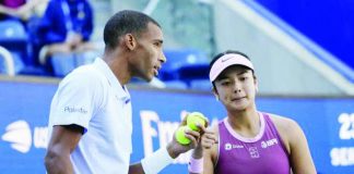 Alexandra Eala talks to mixed doubles partner Felix Auger-Aliassime during their US Open match. REUTERS