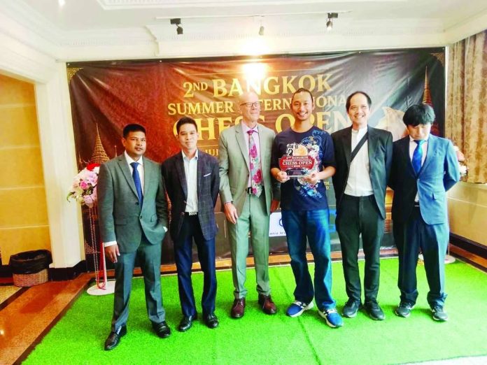 sports_Ilonggo_compressed_resized Ilonggo chess player John Paul De Guzman proudly displays his trophy after emerging champion of the 2nd Bangkok Summer International Chess Open Standard Challenger in Bangkok, Thailand, adding another international title to his growing list of achievements. CONTRIBUTED PHOTO