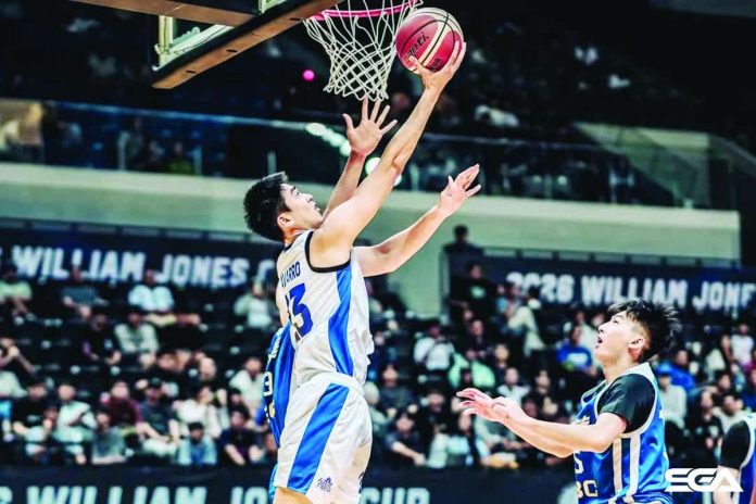 Strong Group Athletics-Pilipinas’ William Navarro goes for a reverse basket against the defense of Chinese Taipei Blue during their 2026 William Jones Cup encounter in New Taipei City, Taiwan. SGA