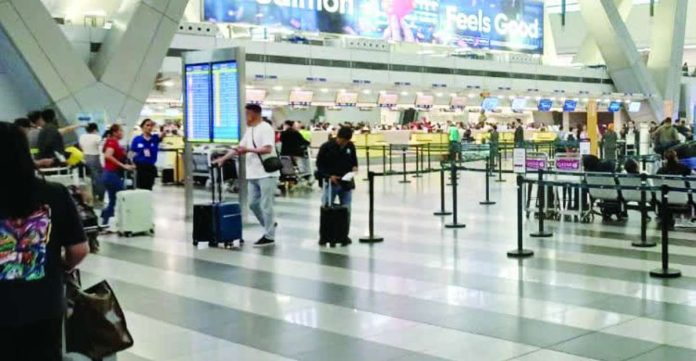 travel_tax.JPG_resized International passengers queue at airline check-in counters inside the Ninoy Aquino International Airport (NAIA) Terminal 3. The Senate is prioritizing the passage of a measure this year to abolish the travel tax to stimulate tourism and provide financial relief to outbound travelers. PN PHOTO