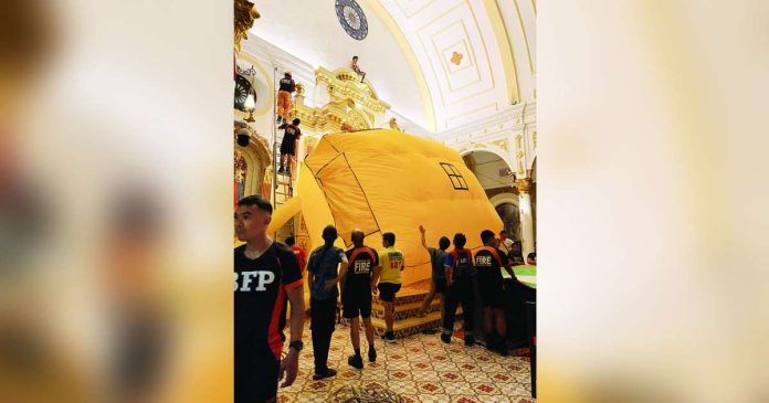 Bacolod cathedral copy_superimposed Emergency responders rescue a man who climbed onto the altar area of San Sebastian Cathedral in Bacolod City on September 26, 2026. Responders placed an inflatable jump cushion below the elevated area, where the man safely landed. BFP-BACOLOD PHOTO