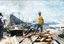More than 20 children killed in Congo school fire A man stands in piles of rubble and corrugated iron left by a school fire in he Democratic Republic of Congo while three other people stand on the left of the picture. The rubble seems to go on for some distance and the air is hazy. REUTERS