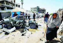 Israel captures Hamas security chief as strikes kill 4 during Gaza raid An elderly woman walks past a destroyed vehicle following an Israeli strike in the Rimal neighborhood of Gaza City on September 1, 2026. AFP VIA GETTY IMAGES