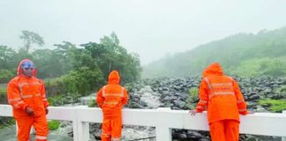 Personnel of the City Disaster Risk Reduction and Management Office closely monitor water flow in Canlaon City on Tuesday amid possible flooding and lahar flows from Mt. Kanlaon. CANLAON CDRRMO PHOTO