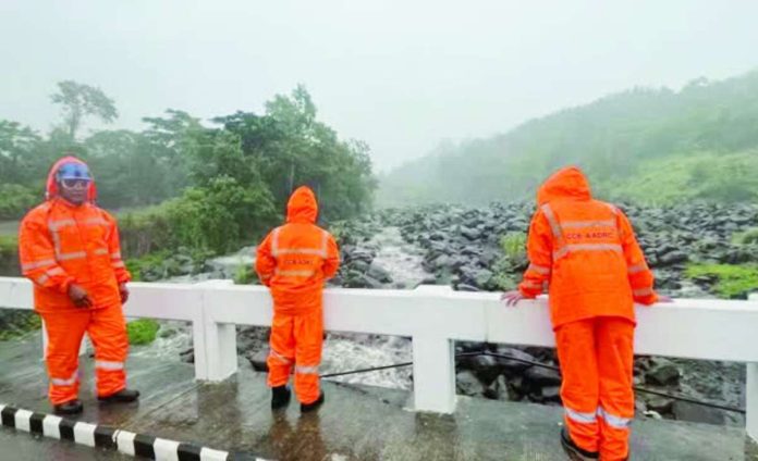 Kanlaon_mudflows_compressed_resized Personnel of the City Disaster Risk Reduction and Management Office closely monitor water flow in Canlaon City on Tuesday amid possible flooding and lahar flows from Mt. Kanlaon. CANLAON CDRRMO PHOTO