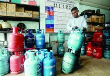AS OIL PRICES SURGE Marcos suspends LPG, kerosene excise taxes A worker prepares liquefied petroleum gas (LPG) tanks for delivery at a store in Paco, Manila. President Ferdinand R. Marcos Jr. has suspended the fuel excise tax on LPG and kerosene amid elevated fuel prices and their potential impact on consumers and the broader economy. PNA