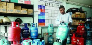 A worker prepares liquefied petroleum gas (LPG) tanks for delivery at a store in Paco, Manila. President Ferdinand R. Marcos Jr. has suspended the fuel excise tax on LPG and kerosene amid elevated fuel prices and their potential impact on consumers and the broader economy. PNA