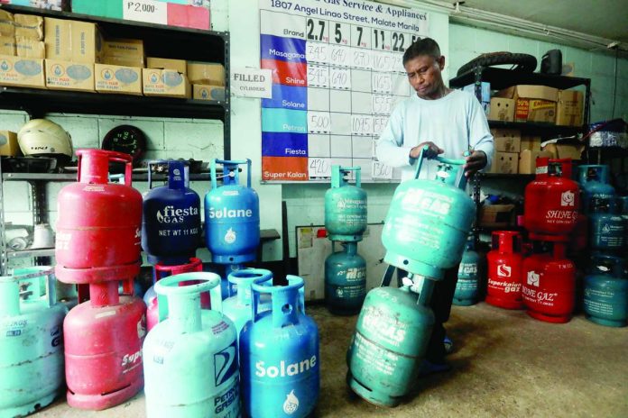 Nation_Marcos_suspends_copy_compressed_resized A worker prepares liquefied petroleum gas (LPG) tanks for delivery at a store in Paco, Manila. President Ferdinand R. Marcos Jr. has suspended the fuel excise tax on LPG and kerosene amid elevated fuel prices and their potential impact on consumers and the broader economy. PNA