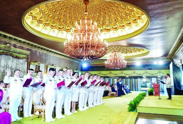 Nation_PCG_copy_compressed_resized President Ferdinand R. Marcos Jr. (right) on Tuesday urged newly promoted Philippine Coast Guard flag officers to lead with courage and integrity as they take on greater responsibilities in protecting Filipinos and the country’s waters. PCO
