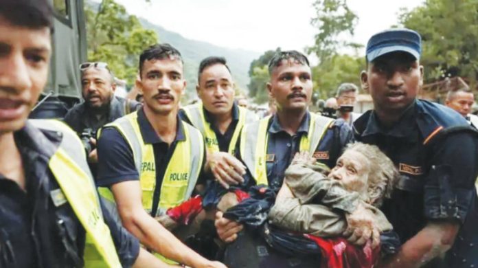 Police officers carry a survivor from the flash floods in Nepa’'s Nuwakot district. Preliminary investigations have pointed to a collapsed glacier as the cause of the flash flood on the Nepal-Tibet border, highlighting the issue of rapidly melting Himalayan ice, scientists say. REUTERS