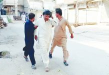 At least 21 killed after vehicle loaded with explosives rams Pakistan mosque Three men move quickly on a road after a blast occurred at a mosque building near police headquarters in Pakistan. REUTERS