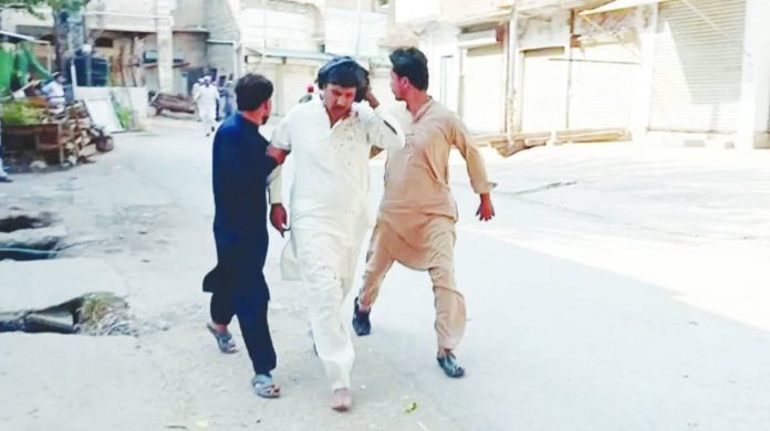 Pakistan Three men move quickly on a road after a blast occurred at a mosque building near police headquarters in Pakistan. REUTERS