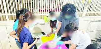 Personnel of the Toboso Primary Health Care Facility examined the body of an infant found wrapped in cloth and placed inside a rice sack in Sitio Maaswa, Barangay General Luna, Toboso, Negros Occidental, on September 3. PRO-NIR PHOTO