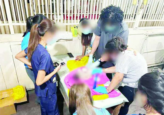 Personnel of the Toboso Primary Health Care Facility examined the body of an infant found wrapped in cloth and placed inside a rice sack in Sitio Maaswa, Barangay General Luna, Toboso, Negros Occidental, on September 3. PRO-NIR PHOTO