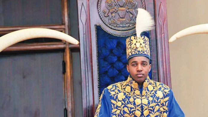 Uganda King Oyo pictured at 18 during his coronation wearing a gold embroidered jacket and hat. King Oyo ascended to the throne at the age of three but was crowned on reaching adulthood at 18 in 2010. AFP VIA GETTY IMAGES