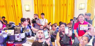 Beneficiaries of the Unified Package for Livelihoods, Industry, Food, and Transport (UPLIFT) program display their mobile phones showing the financial aid received via e-wallet during the pilot launch of the DSWD digital payout system at the Bacolod City Government Center lobby on Sept. 22.