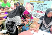 ‘40-YEAR-OLD STRUGGLE’ | Gov’t urged: Pass Magna Carta for Barangay Health Workers A barangay health worker gives a boy his measles vaccine shot as part of the government’s mass vaccination campaign in the Bangsamoro Autonomous Region in Muslim Mindanao. PHOTO COURTESY OF RURAL HEALTH UNIT PAGALUNGAN