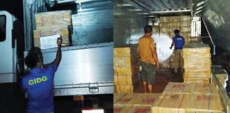 Operatives of the CIDG-Negros Occidental Provincial Field Unit inspect master cases of illicit cigarettes and cargo inside a wing van truck following a buy-bust operation in Barangay 3, Isabela, Negros Occidental, early Friday morning, September 25. The operation led to the arrest of three suspects. CIDG PHOTOS