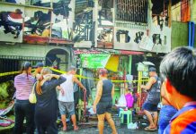 Residents gather outside a gutted residential property on Wednesday morning, Sept. 2, 2026, following a late-night fire in Zone 8, Barangay Veterans Village, City Proper, Iloilo City. The fire damaged nine residential structures, displaced 13 families, and injured four individuals. ALLEN ANIMAS/PN