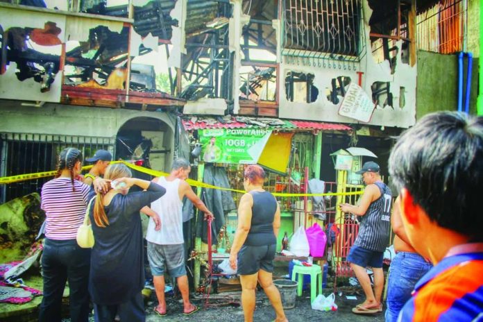 fire1_compressed_resized Residents gather outside a gutted residential property on Wednesday morning, Sept. 2, 2026, following a late-night fire in Zone 8, Barangay Veterans Village, City Proper, Iloilo City. The fire damaged nine residential structures, displaced 13 families, and injured four individuals. ALLEN ANIMAS/PN