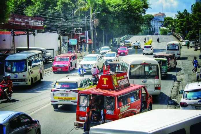 Commuters and public utility vehicles navigate a busy street in La Paz, Iloilo City on Monday morning, Sept. 28, as the newly approved public transport fare increases officially took effect. Low-income workers and parents feared rising transportation costs will consume funds needed for essential household expenses, including food and schooling. ALLEN ANIMAS/PN