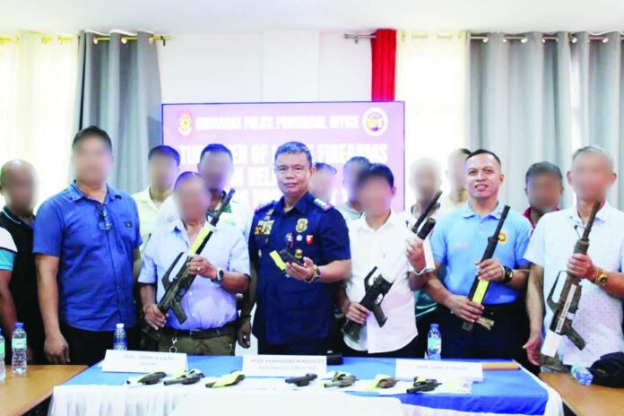 guimaras_loose_guns_copy_compressed_resized Guimaras Police Provincial Office (GPPO) director Colonel Ferdinand N. Navales (center) leads police officials and local chief executives during the ceremonial turnover of 101 surrendered loose firearms. Guimaras achieved a 100 percent participation rate in Project RTT 3389 after all 98 barangays across its five municipalities voluntarily surrendered at least one unregistered firearm to authorities. PRO-6 PHOTO