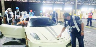 Customs officers inspect a luxury car at Manila International Container Port. Under the proposed Progress Bill, the Department of Finance is looking to raise the tax rate on luxury and nonessential goods to 25 percent from 20 percent. FILE PHOTO COURTESY OF BOC