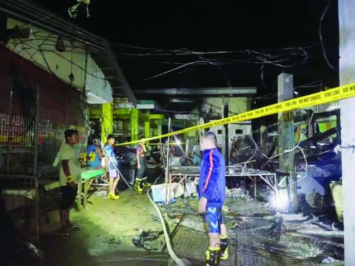 market_fire_compressed_resized Firefighters cordoned off the charred remains of the frozen goods section at the Patnongon Public Market in Barangay Poblacion, Patnongon, Antique after a late-night fire damaged two stalls and left P600,000 in estimated damages on Tuesday, Sept. 15, 2026. ELVIC F. BALLENAS PHOTO