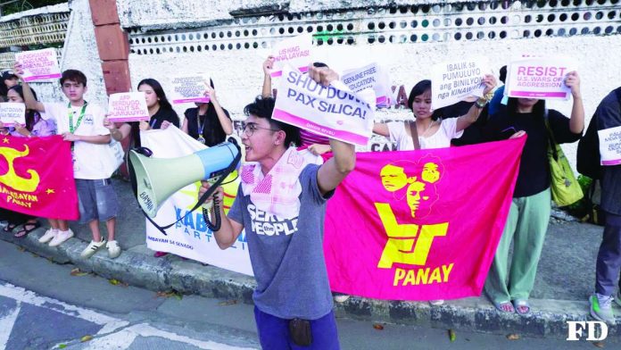 neljoy_Pax_compressed_resized Protesters gather in Iloilo City to oppose the United States-led “Pax Silica” initiative and artificial intelligence data centers development, warning that resource-intensive technology projects could strain Panay Island’s power and water supplies and threaten agricultural lands and farmers’ livelihoods. FORUM DIMENSIONS (WVSU)