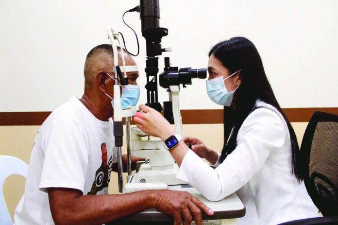 Ophthalmologist Dr. Aliette Alyssa R. Mesa of Western Visayas Medical Center in Mandurriao, Iloilo City examines the eyes of a 69-year-old patient suffering from blurry vision. Early detection of an eye problem can prevent far more severe complications down the line, especially since vision is so fundamental to how people interact with the world. ALLEN ANIMAS/PN