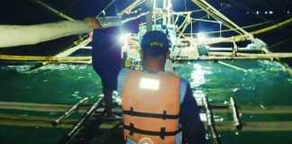 A member of the Iloilo Provincial Bantay Dagat Task Force approaches one of two fishing boats intercepted for alleged “siklob” fishing off Concepcion, Iloilo. PHOTO FROM ILOILO PROV’L ADMINISTRATOR RAUL BANIAS