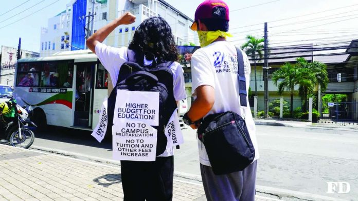 neljoy_youth_copy_compressed_resized Youth activists take their campaign to the streets of Iloilo City, carrying placards calling for a higher education budget, an end t campus militarization, and no increase in tuition and other school fees. FORUM DIMENSIONS - WVSU